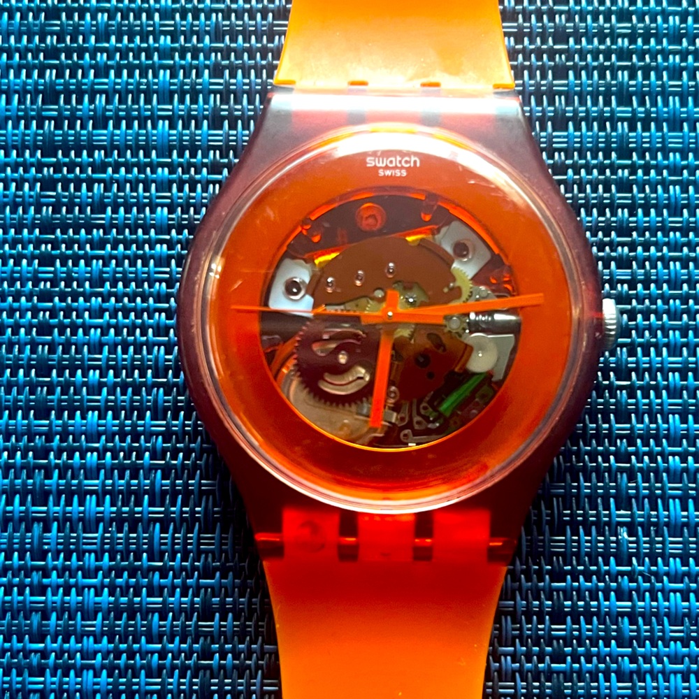Orange skeleton swatch watch